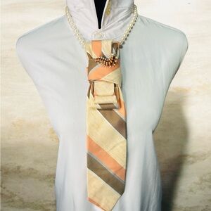 Chic Cream and Orange Necktie with Caterpillar Brooch